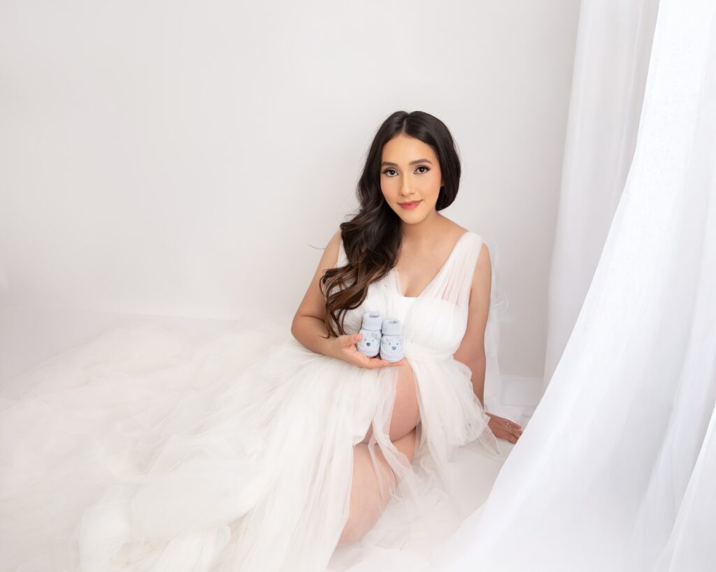 Phoenix maternity photos pregnant mama in white gown with her baby boy shoes 