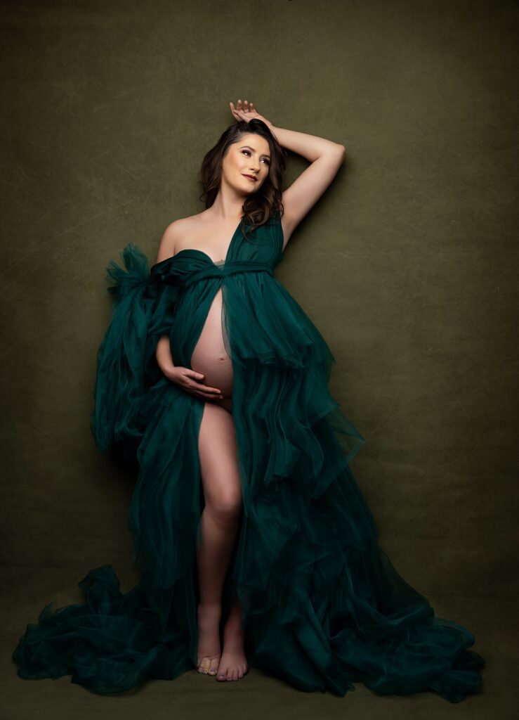 Editorial maternity portrait in emerald green gown at Phoenix photography studio