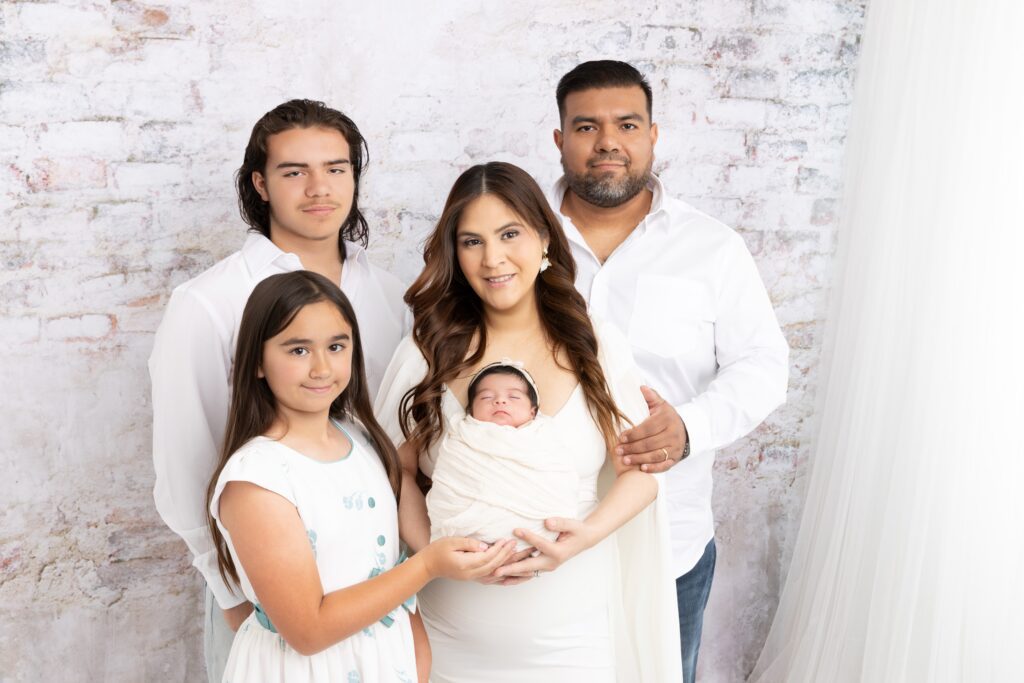 Family of five with newborn during an elegant Phoenix newborn photography session.